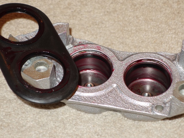 The front is a 3-pot caliper so one half has two smaller pistons with a combined dust shield