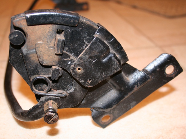 The reclining mechanism showing the connecting bar which operates a toothed locking mechanism and also one of the return springs