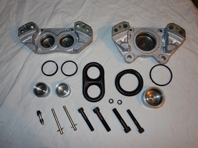 The components for the front calipers - including the small circular seals between the two halves