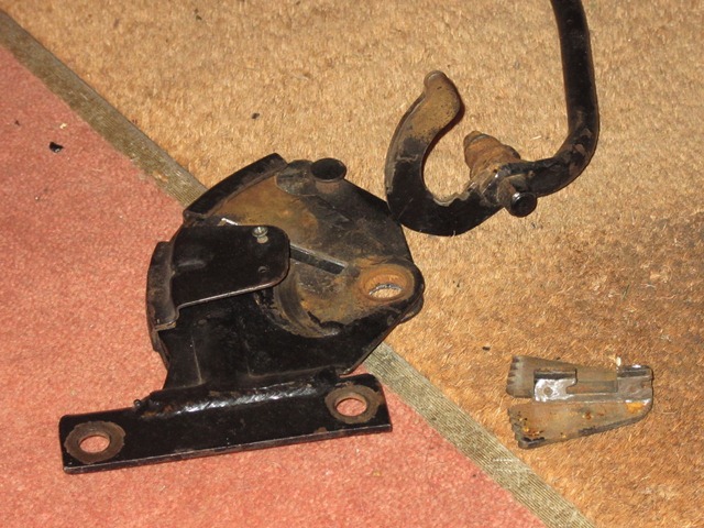 The dismantled reclining mechanism. The reclining connecting bar interlocks with the toothed wedge piece to lock and release the seat back