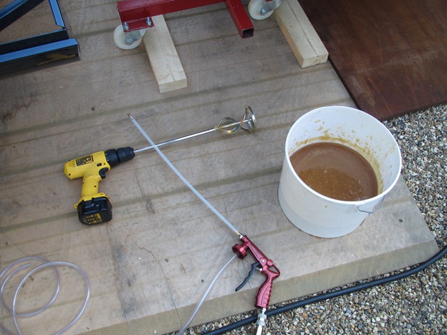 The rustproofing gun and heated waxoyl ready for spraying